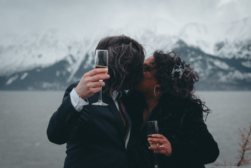 An Alaska Elopement - a smooch for the couple after popping some champs