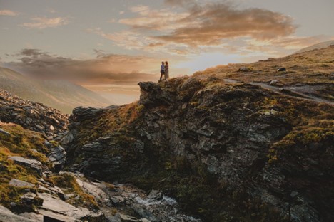 Golden light surrounds Brooke and Fabi at sunset in Hatcher Pass