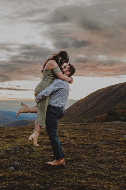 Fabi picks up Brooke and spins her around on the top of Hatcher Pass, Alaska