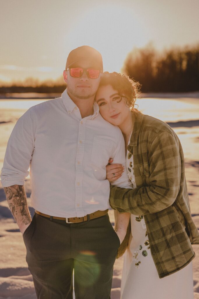 Zack and Zoe cuddle for warmth during photos post-elopement.