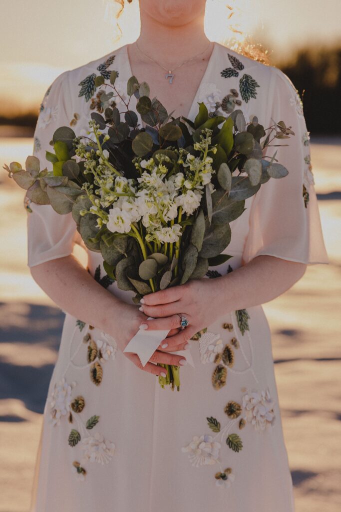 Zoe's dress boasted floral patterns that matched her eucalyptus bouquet.