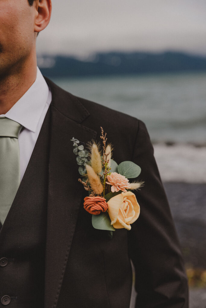 A photo featuring the boutineer of the groom who had a beach wedding at Lowell Point in Seward, Alaska.